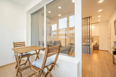 a dining room and living room with a table and chairs at Harmony Suite in Sofia