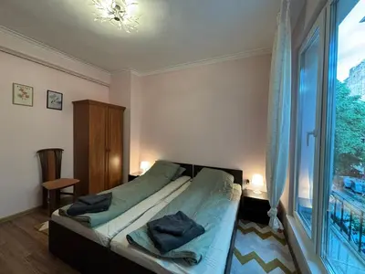 a bedroom with a bed and a large window at Quiet 2 bedrooms downtown apart in Sofia
