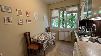 a kitchen with a table and a sink at Quiet 2 bedrooms downtown apart in Sofia