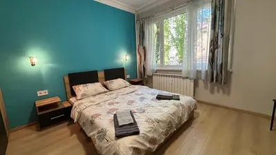 a bedroom with a bed and a large window at Garden view top center apart in Sofia