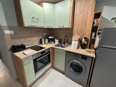 a kitchen with a washing machine and a washer at Garden view top center apart in Sofia
