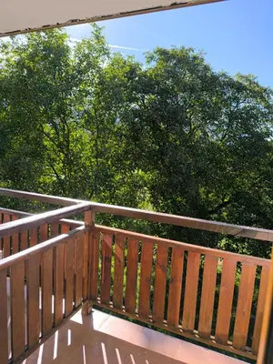 a wooden deck with trees in the background at Cozy nature stay, free Bottle of good Wine, Great view, free Parking in Bansko