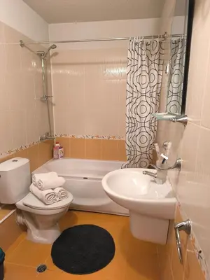 a bathroom with a toilet and a sink and a tub at Cozy nature stay, free Bottle of good Wine, Great view, free Parking in Bansko