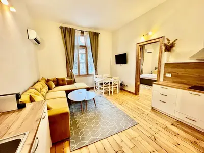 a living room with a couch and a table at SKYLER VINTAGE APARTMENTS in Plovdiv
