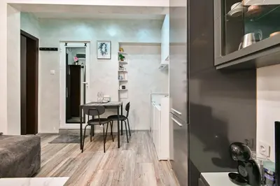 a small kitchen and dining room with a table and chairs at Tsar Simeon 65 Studio (With Parking space) in Sofia