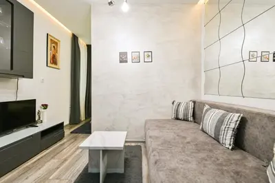 a living room with a couch and a tv at Tsar Simeon 65 Studio (With Parking space) in Sofia