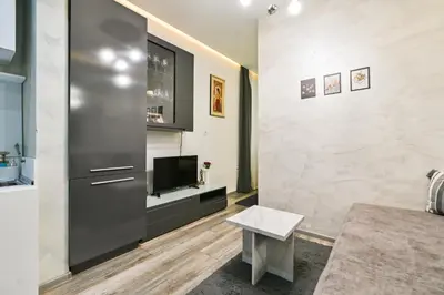 a living room with a tv and a couch at Tsar Simeon 65 Studio (With Parking space) in Sofia