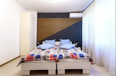 a bedroom with a large bed with blue pillows at 2 Designer Apartments Seconds Away From Тhe Main Street, FREE Parking in Sofia