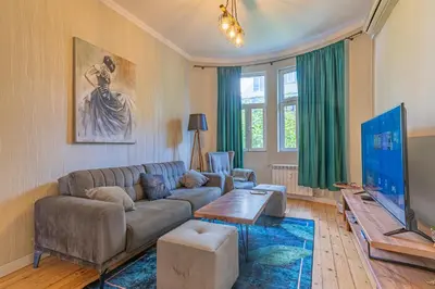 a living room with a couch and a table at 2 Designer Apartments Seconds Away From Тhe Main Street, FREE Parking in Sofia