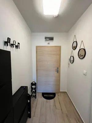 a hallway with a wooden door in a room at Sao Paolo warm and cosy Studio in lively district in Sofia