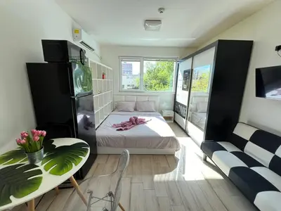 a bedroom with a bed and a table and a couch at Sao Paolo warm and cosy Studio in lively district in Sofia