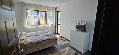a bedroom with a bed and a television in it at Д и В 3 - D & V 3 Apartment in Sandanski