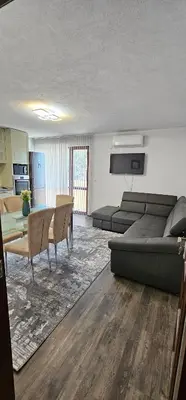 a living room with a couch and a table at Д и В 3 - D & V 3 Apartment in Sandanski