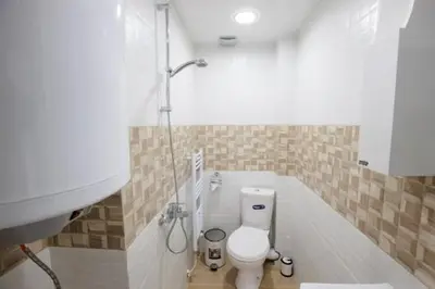 a bathroom with a toilet and a sink at WhiteBoxApartment in Kyustendil