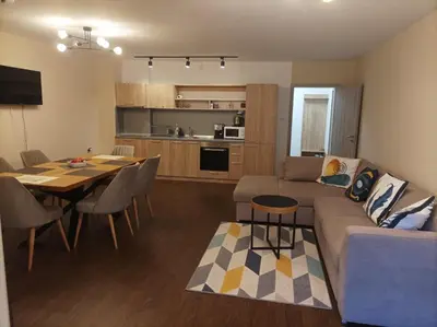a living room and kitchen with a couch and a table at Terra apartment in Sandanski