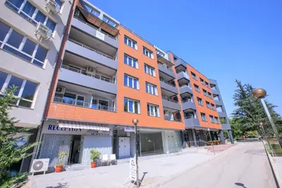 an orange brick building on a city street at Terra apartment in Sandanski