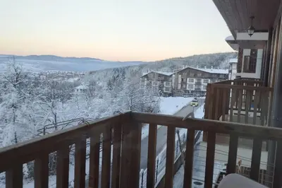 a view from a balcony with snow on the ground at 2BR mountain view, SPA, parking, ski piste in Bansko