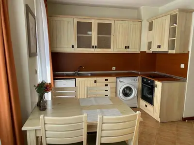 a small kitchen with a table and a washing machine at Pirin Golf private studio in Razlog