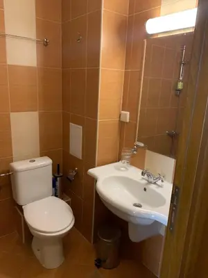 a bathroom with a toilet and a sink at Studio 5 in Pirin Golf in Razlog