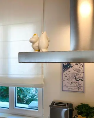 two birds sitting on a shelf above a window at Este Apart Historical Center in Sofia