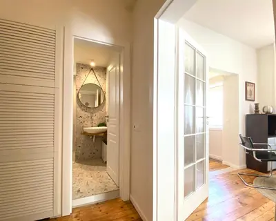 a hallway with a door leading to a bathroom at Este Apart Historical Center in Sofia