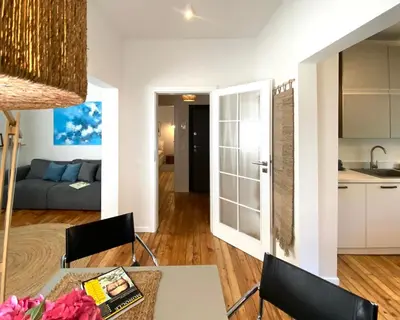 a kitchen and living room with a table and chairs at Este Apart Historical Center in Sofia