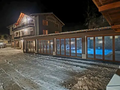 a building at night with the lights on at Къща за гости МИЧЕВИ in Shipkovo