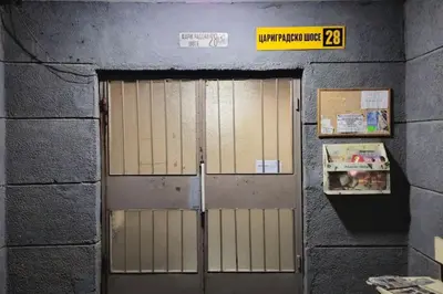 a door in a building with a sign on it at Panorama Apartment in Plovdiv