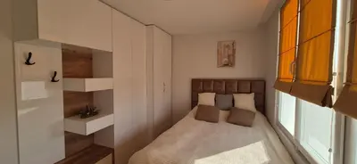 a small bedroom with a bed and a window at Panorama Apartment in Plovdiv