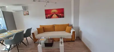 a living room with a couch and a table at Panorama Apartment in Plovdiv