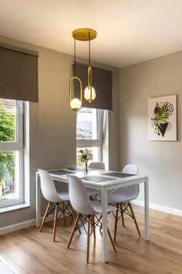 a dining room with a table and chairs at The House-Kamenitza Апартамент и релакс зона in Velingrad