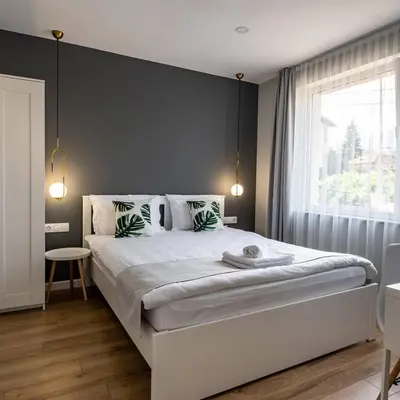 a bedroom with a large bed with a large window at The House-Kamenitza Апартамент и релакс зона in Velingrad