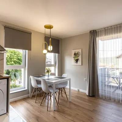a kitchen and dining room with a table and chairs at The House-Kamenitza Апартамент и релакс зона in Velingrad