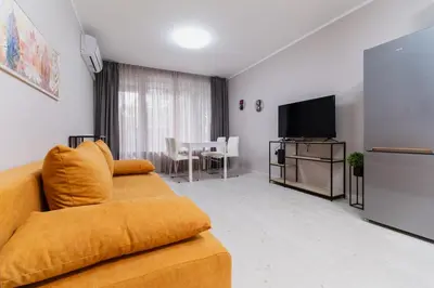a living room with a couch and a flat screen tv at Cozy 2-bed Apartment in Plovdiv