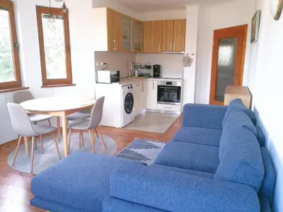 a living room with a blue couch and a table at Sapphire Mountain 2 in Bansko