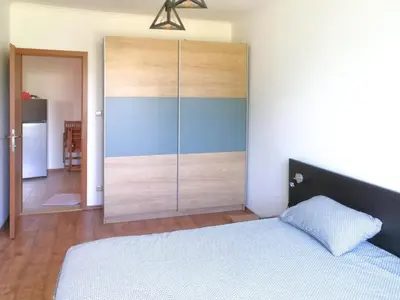 a bedroom with a bed and a large closet at Sapphire Mountain 2 in Bansko
