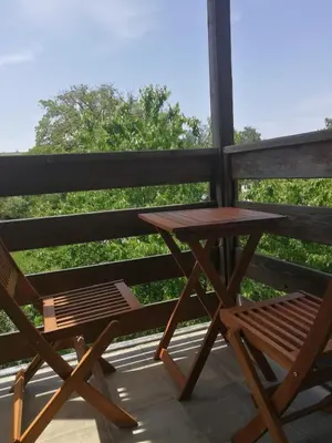 a picnic table and a chair on a porch at Sapphire Mountain 2 in Bansko