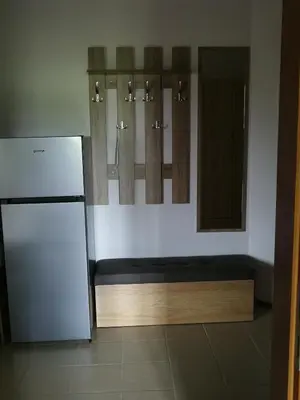 a small kitchen with a refrigerator and a mirror at Sapphire Mountain 2 in Bansko