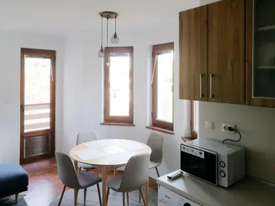 a kitchen with a table and chairs in a room at Sapphire Mountain 2 in Bansko