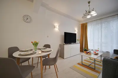 a living room with a table and chairs and a television at Tulip Dreamland in Sofia