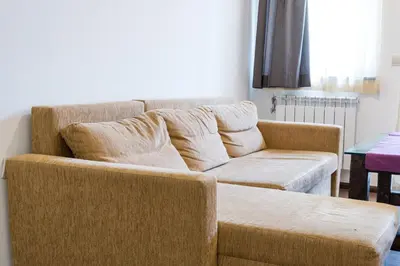 a living room with a couch and a table at Borche Family Homes in Pamporovo