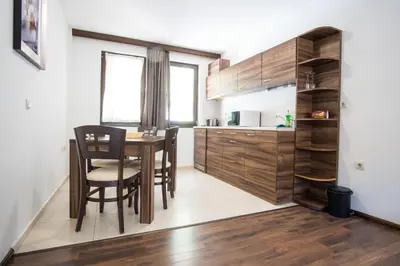 a kitchen and dining room with a table and chairs at Borche Family Homes in Pamporovo