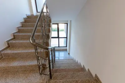 a staircase in a house with a metal handrail at Bissera premium apartments in Sofia