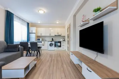 a living room with a flat screen tv on a wall at Bissera premium apartments in Sofia