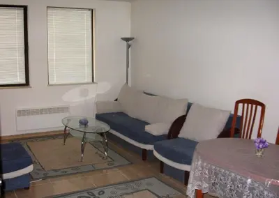 a living room with a couch and a table at Apartment in Complex Monastery 1 in Pamporovo