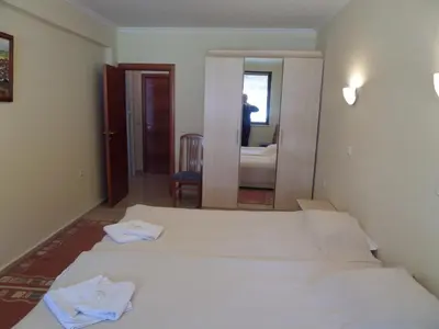 a hotel room with two beds and a mirror at Apartment in Complex Monastery 1 in Pamporovo