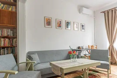 a living room with a couch and a table at Centrally Located Vintage Flat in Sofia