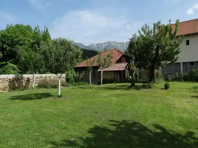 a yard with a house and trees and a fence at Roden Dom Holiday Home in Apriltsi