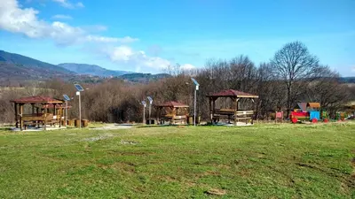 a park with a group of play structures in a field at Roden Dom Holiday Home in Apriltsi