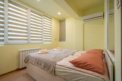 a bedroom with a bed with two towels on it at Top Location Central New & Spacious 3 BDR apt Medical Academy in Sofia